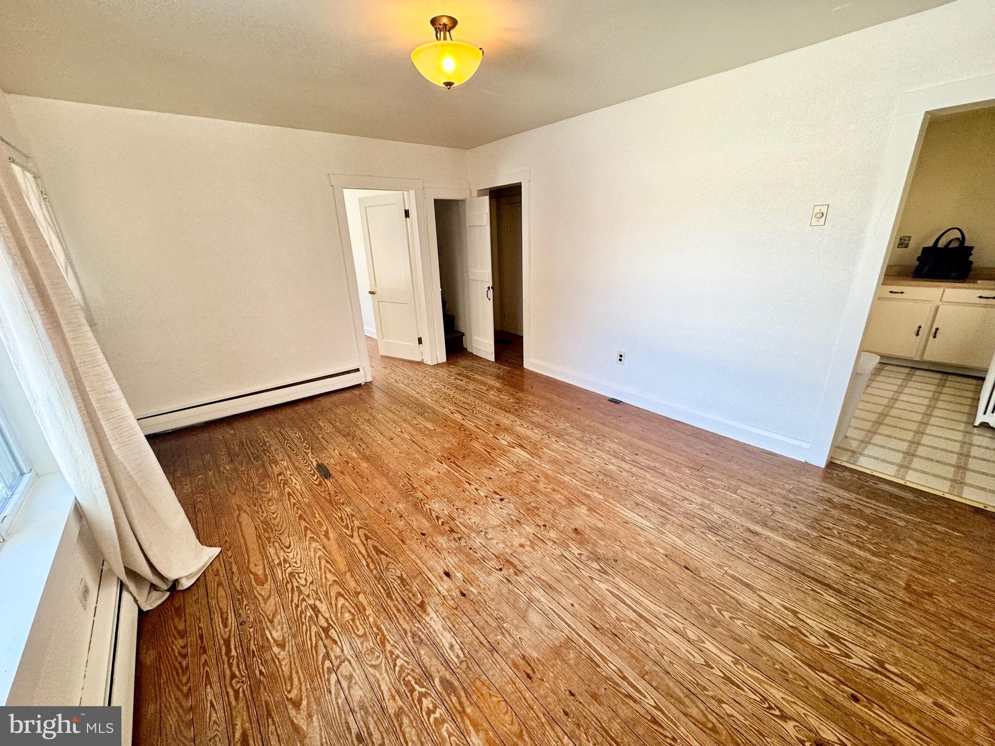 2847 Baltimore Boulevard, Unit B Finksburg, MD 21048 - Photo 8 of 25 a view of an empty room with wooden floor and a window