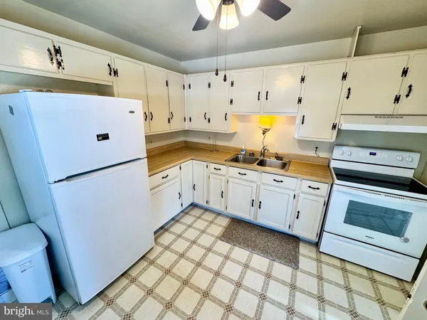 a kitchen with granite countertop cabinets stainless steel appliances and a sink