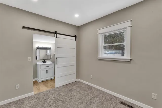 a bathroom with a sink mirror vanity and toilet
