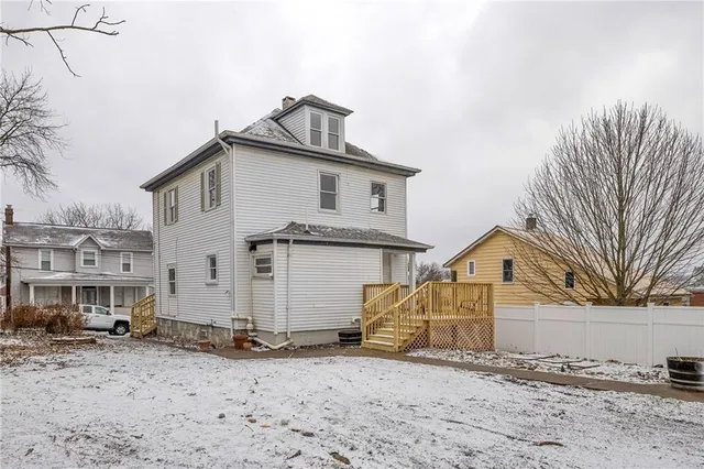 a view of a white house with a snow on the road