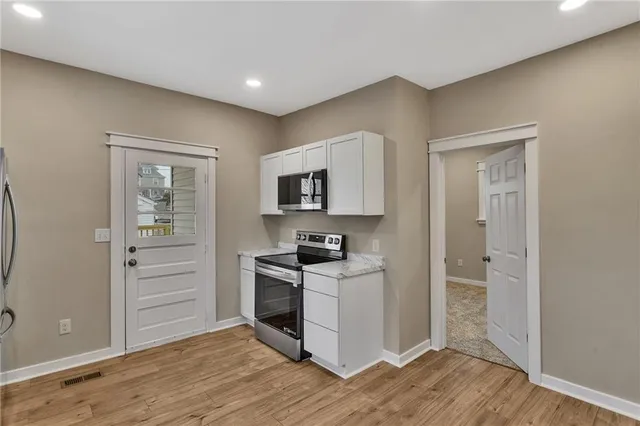 a view of a kitchen cabinets and wooden floor
