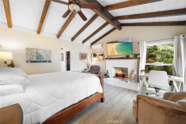 a bedroom with a bed a large window and furniture