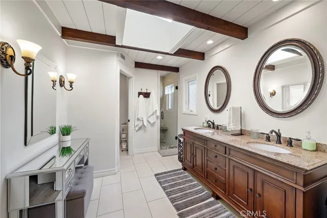 a bathroom with a double vanity sink and a mirror