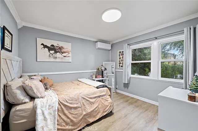 a bedroom with a bed and flat screen tv