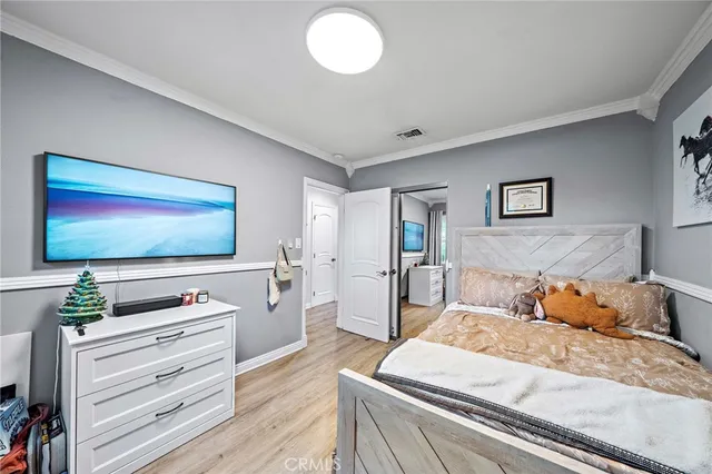 a bedroom that has a bed and a desk