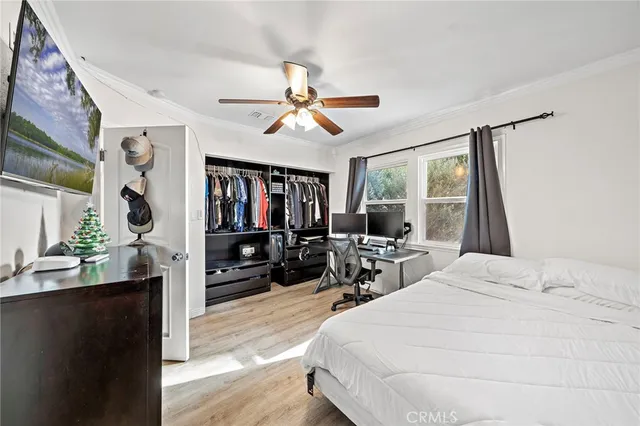 a bedroom with a bed and a chandelier