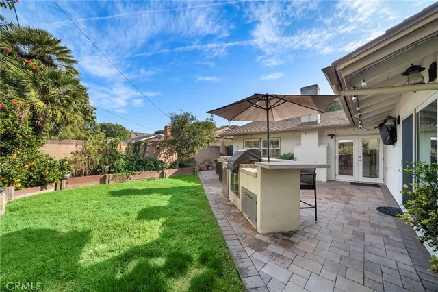 a view of a house with a backyard and a patio