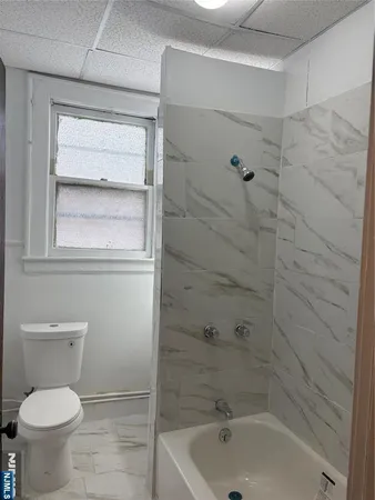 a bathroom with a toilet and shower