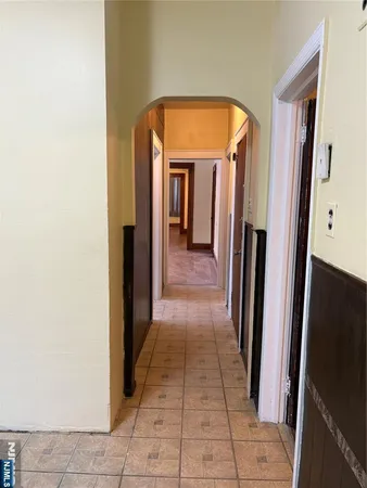 a hallway with sliding door and stairs