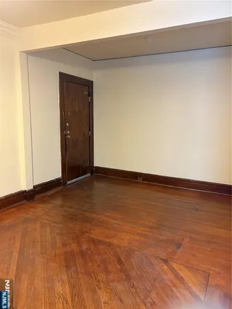 a view of an empty room and wooden floor