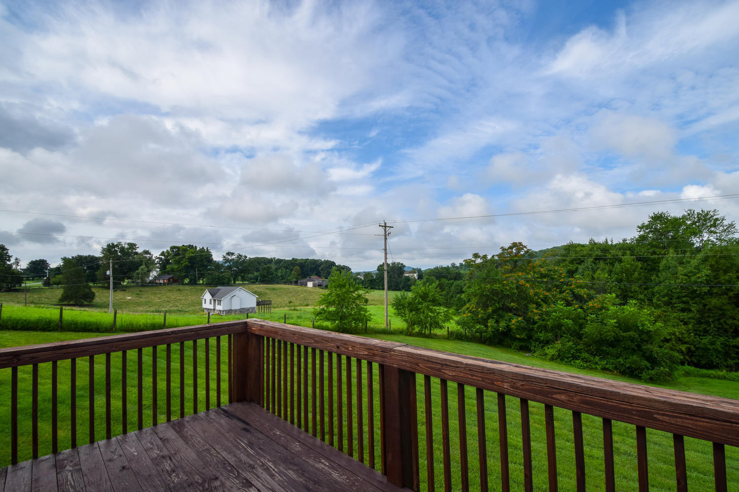1167 Mill Iron Road Goodview, VA 24095 - Photo 16 of 19 a view of a balcony with wooden fence