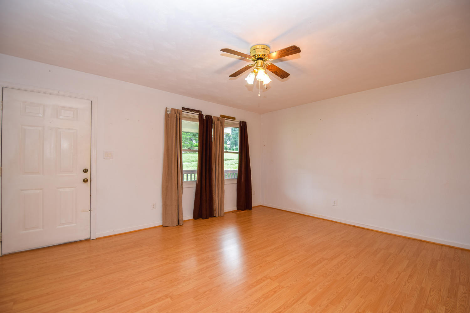 1167 Mill Iron Road Goodview, VA 24095 - Photo 3 of 19 a view of an empty room with chandelier fan and window
