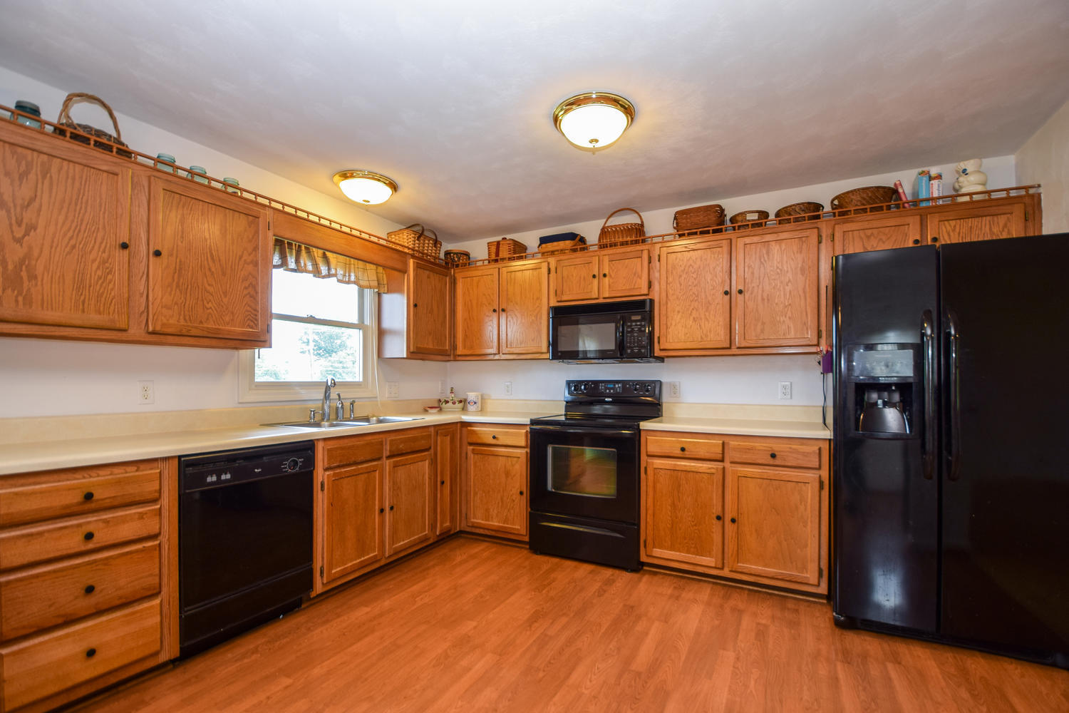1167 Mill Iron Road Goodview, VA 24095 - Photo 5 of 19 a kitchen with stainless steel appliances granite countertop a stove a sink dishwasher and a refrigerator