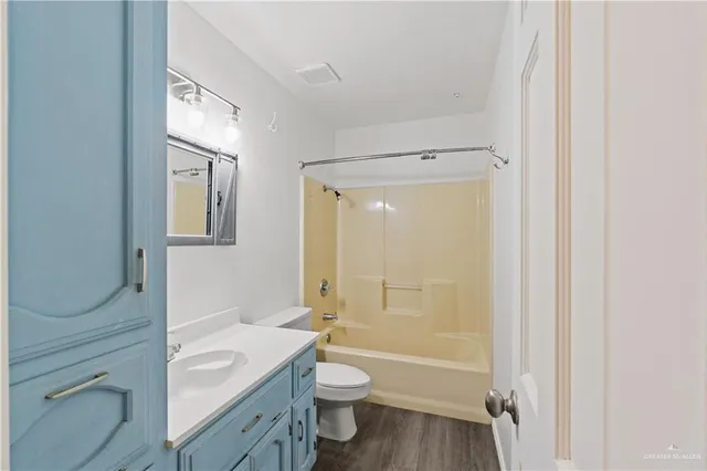 a bathroom with a granite countertop toilet a sink and a bathtub