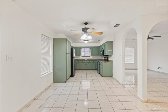 a kitchen with a sink a refrigerator and window