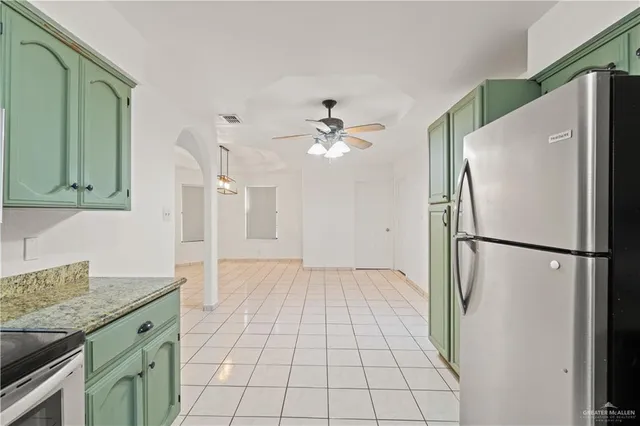 a kitchen with a refrigerator and a sink