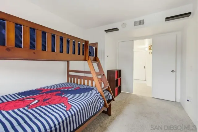 a bedroom with a bed and a book shelf