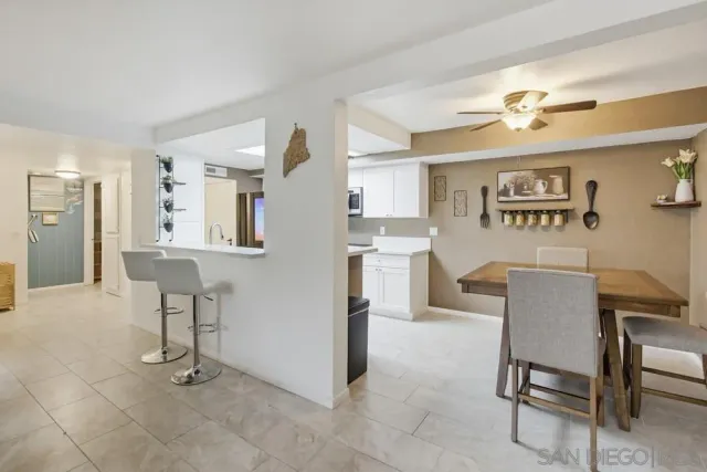 a view of a livingroom with furniture and a kitchen