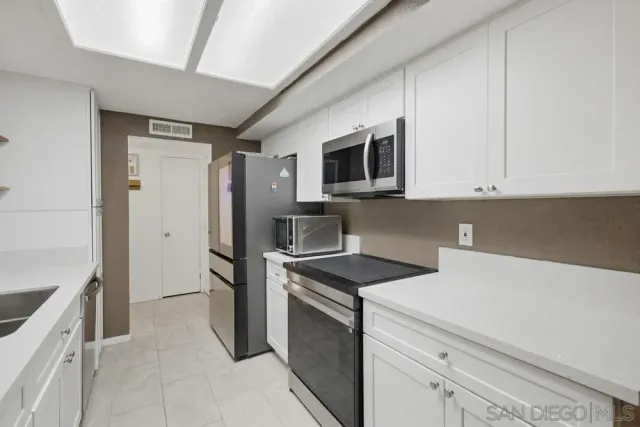 a kitchen with a stove microwave and refrigerator
