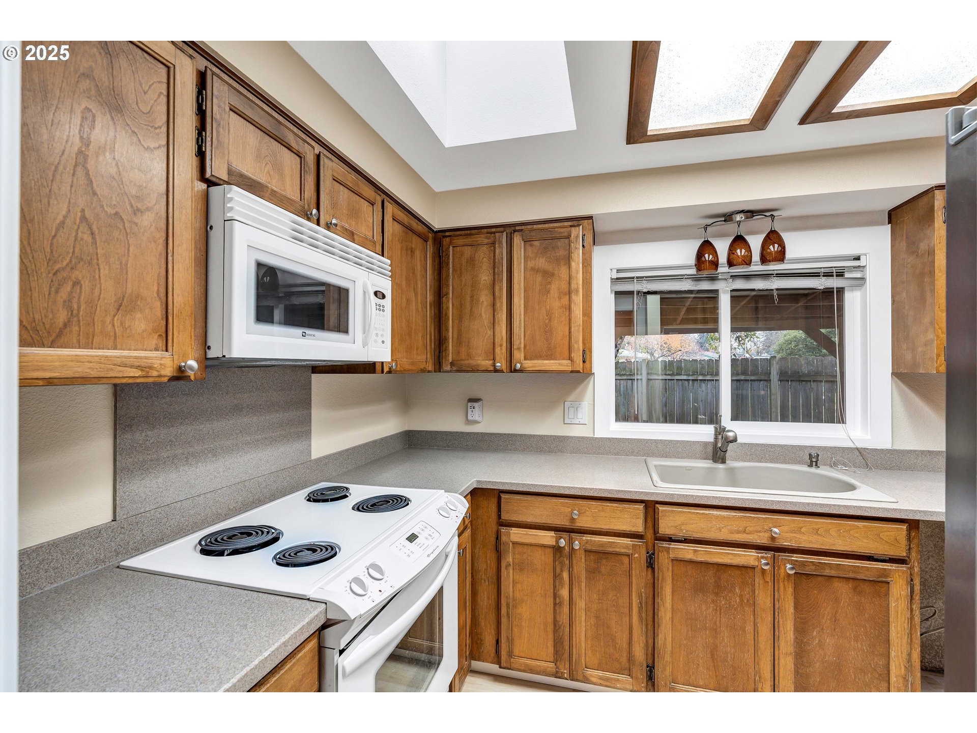 814 Northeast 196th Avenue Portland, OR 97230 - Photo 12 of 44 a kitchen with a stove a sink and a microwave