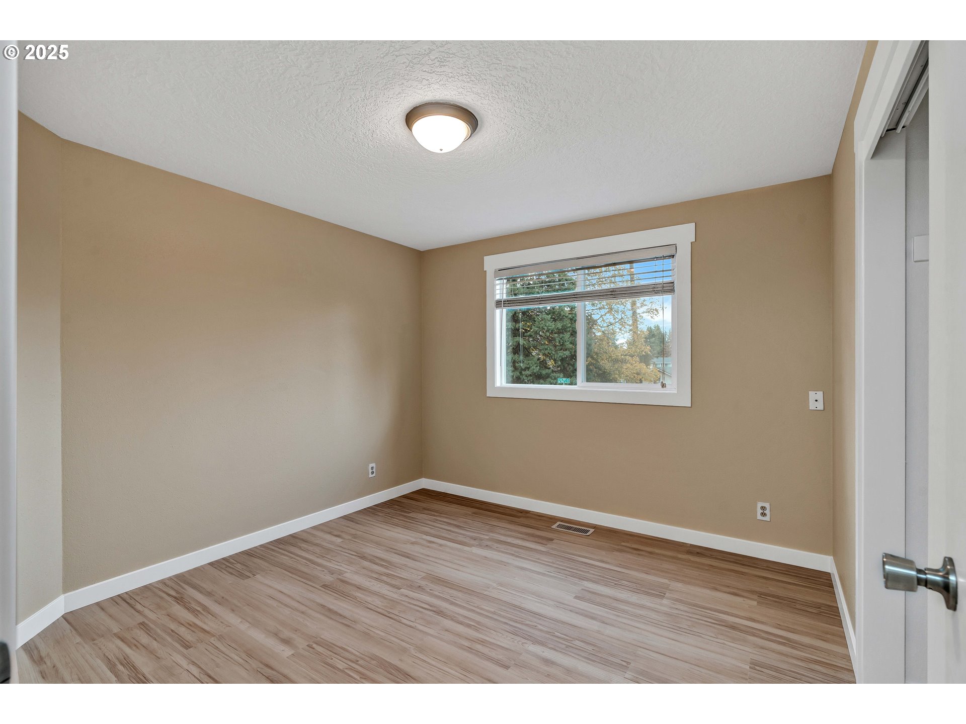 814 Northeast 196th Avenue Portland, OR 97230 - Photo 14 of 44 a view of an empty room with wooden floor and a window