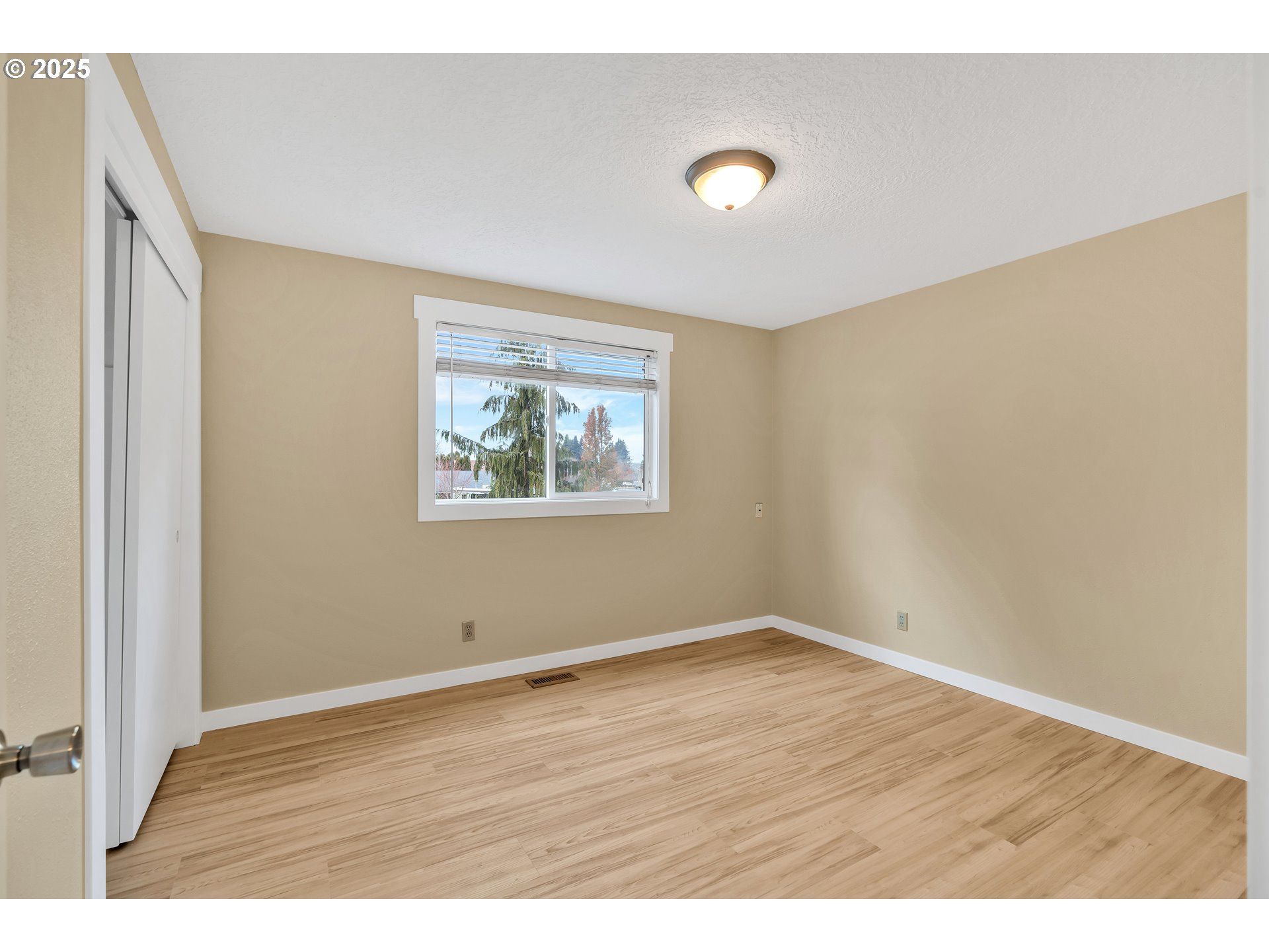 814 Northeast 196th Avenue Portland, OR 97230 - Photo 17 of 44 a view of an empty room with wooden floor and a window