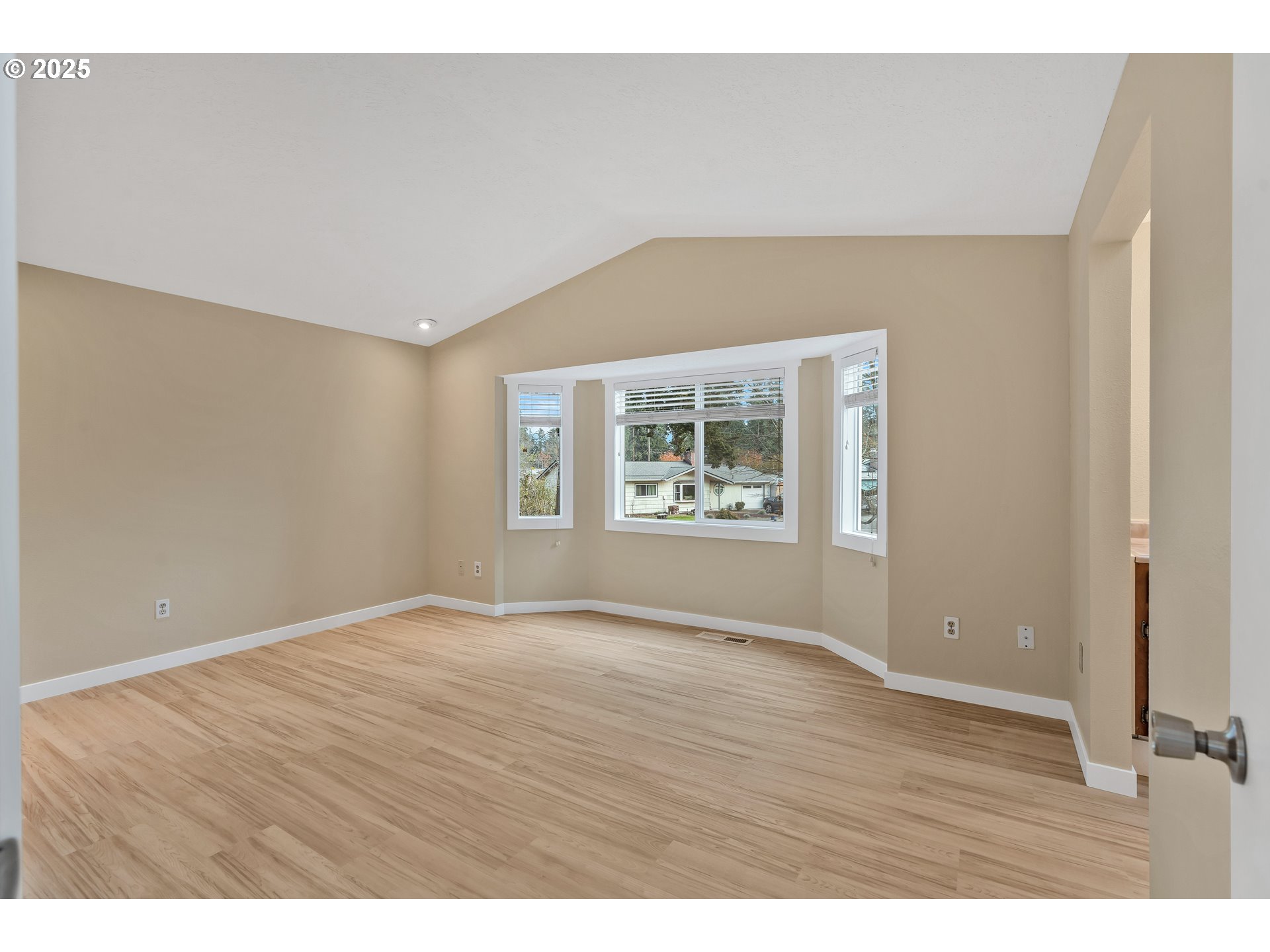 814 Northeast 196th Avenue Portland, OR 97230 - Photo 19 of 44 a view of an empty room with window and wooden floor