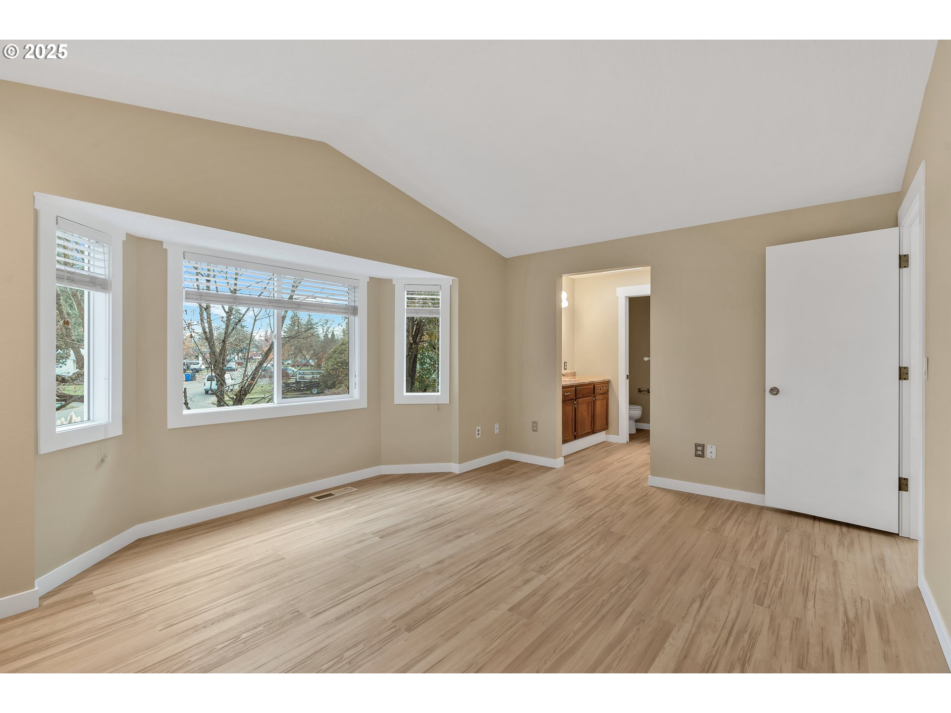 814 Northeast 196th Avenue Portland, OR 97230 - Photo 20 of 44 a view of an empty room with wooden floor and a window