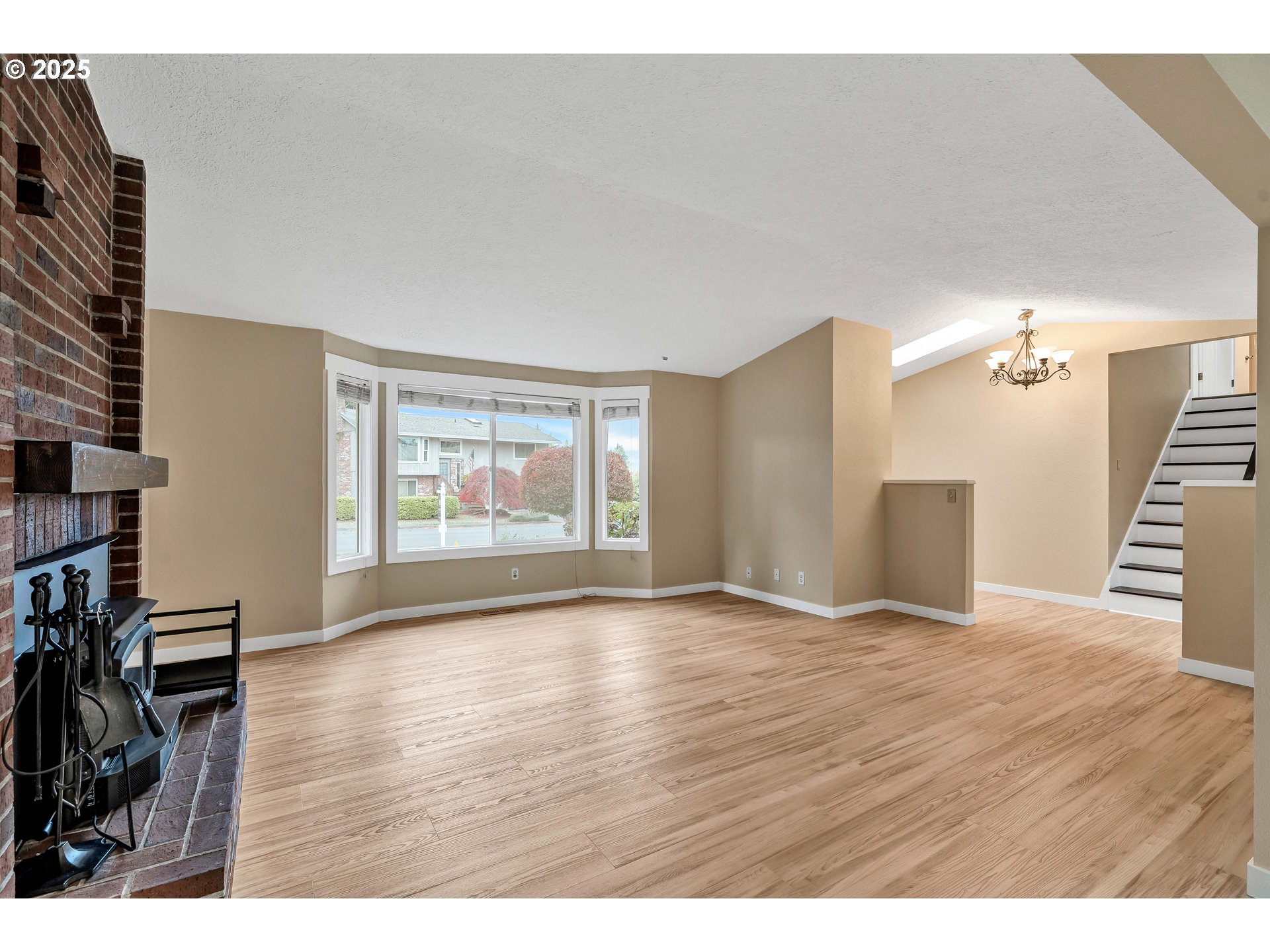 814 Northeast 196th Avenue Portland, OR 97230 - Photo 7 of 44 a view of an empty room with a window and wooden floor