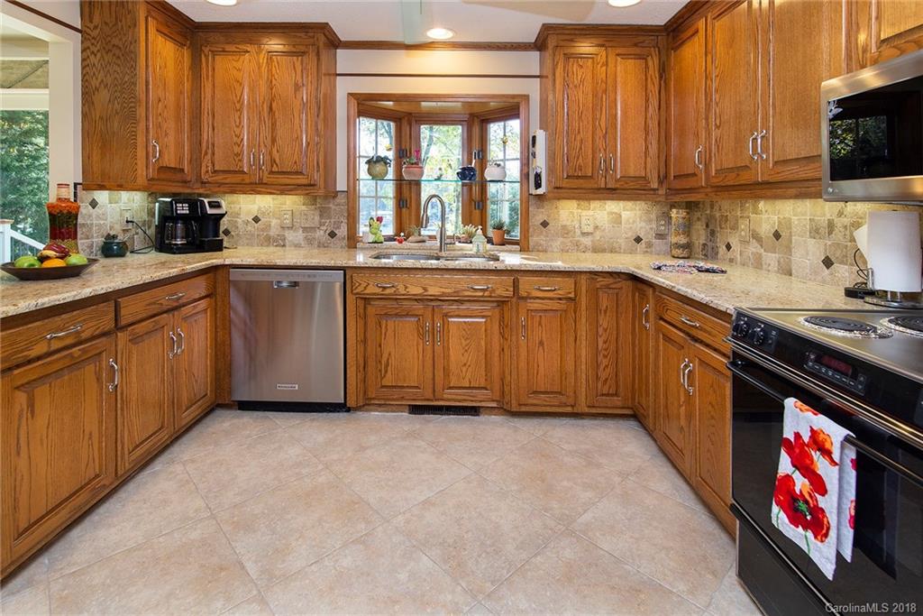 3910 Lake Shore Road South Denver, NC 28037 - Photo 7 of 25 a kitchen with stainless steel appliances granite countertop a stove a sink and a microwave