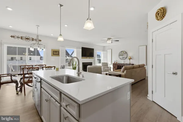 a view of living room with kitchen island furniture and a chandelier