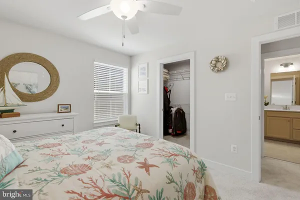 a bedroom with a bed a chandelier and a window