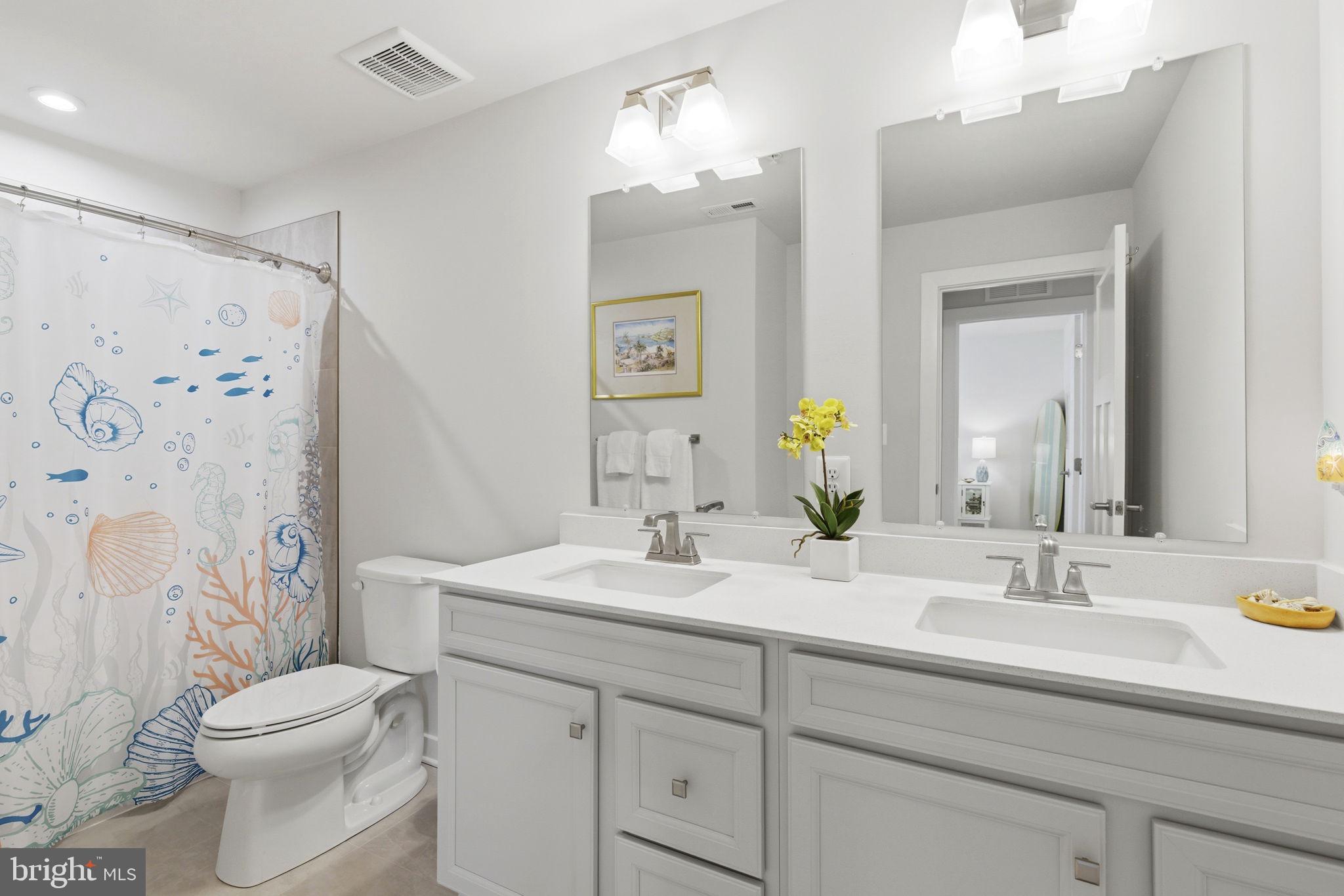 703 Cornerstone Lane Aberdeen, MD 21001 - Photo 28 of 53 a bathroom with a toilet a sink a light fixture and a mirror