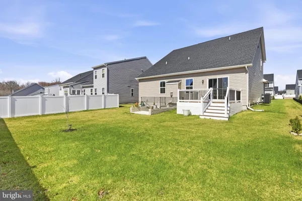 a view of a house with a yard and sitting area