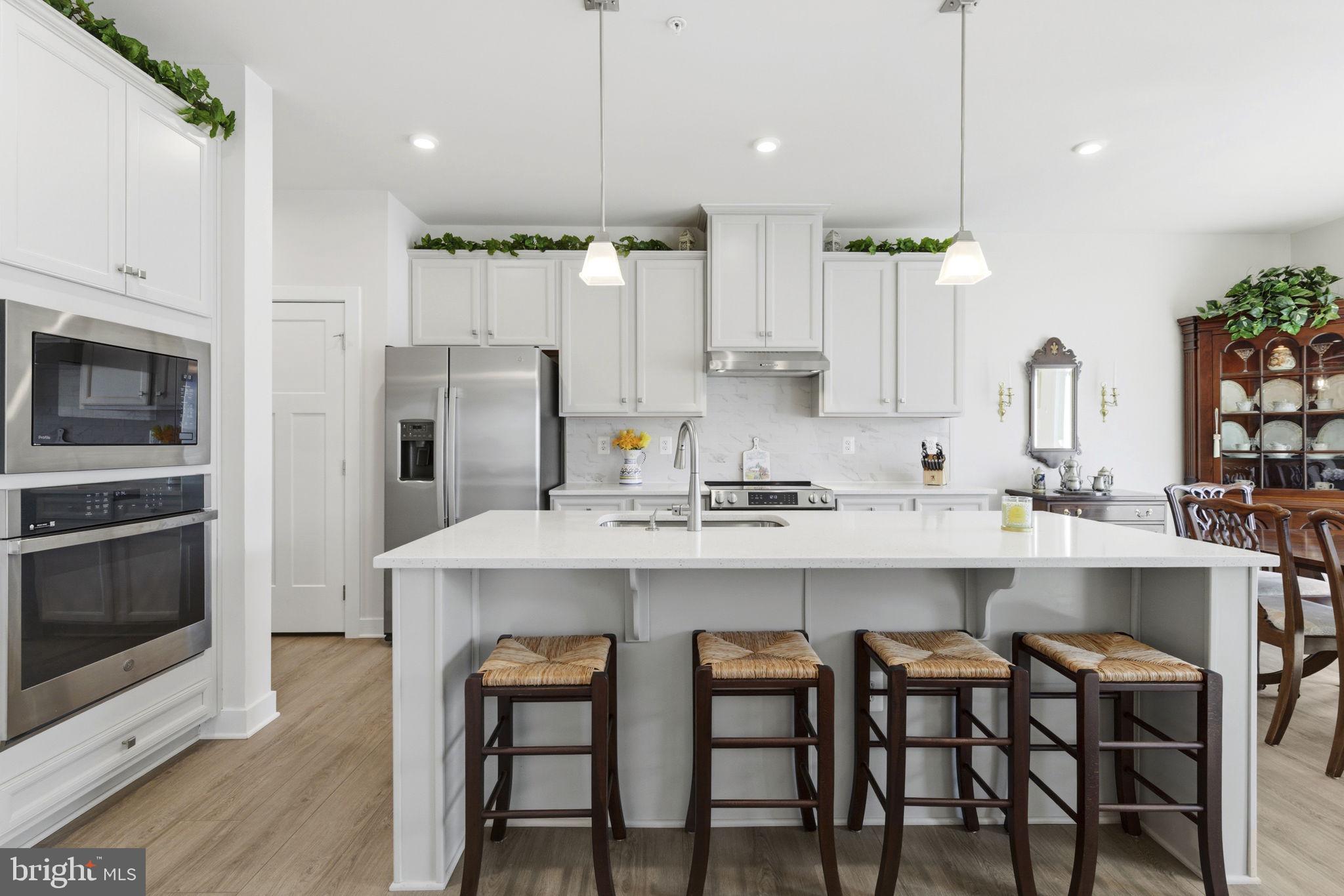 703 Cornerstone Lane Aberdeen, MD 21001 - Photo 9 of 53 a kitchen with white cabinets and stainless steel appliances