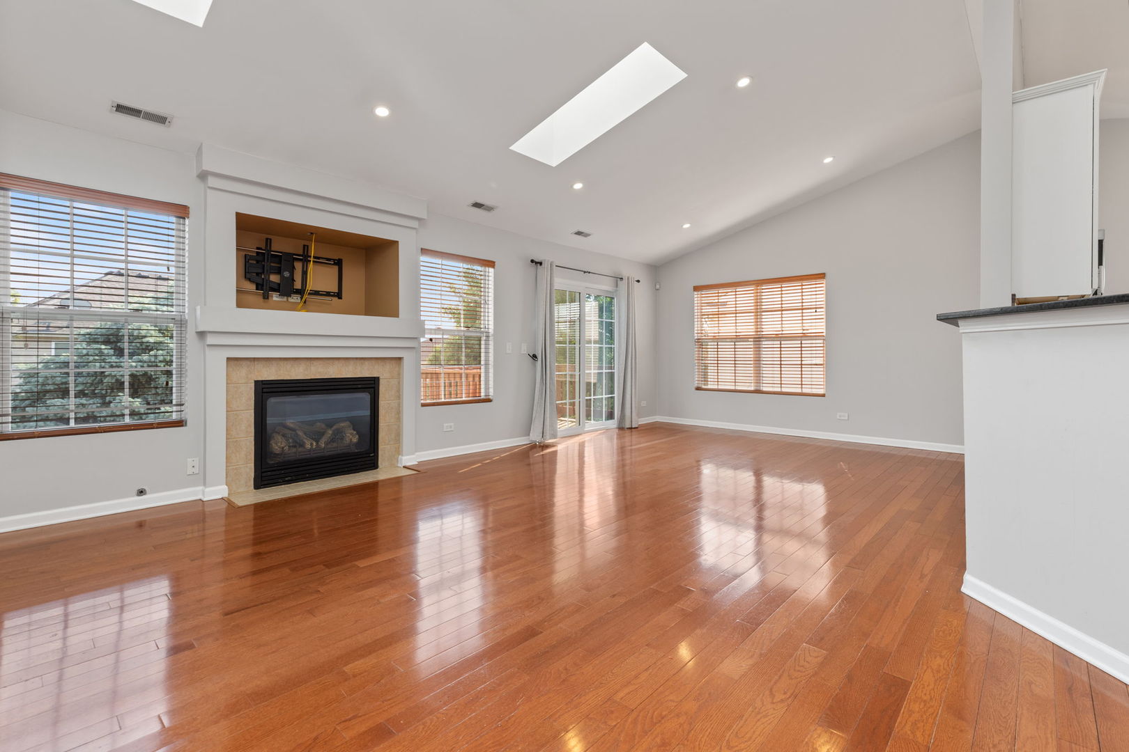 1981 West Cobblestone Road Romeoville, IL 60446 - Photo 5 of 27 a view of an empty room with wooden floor and a window
