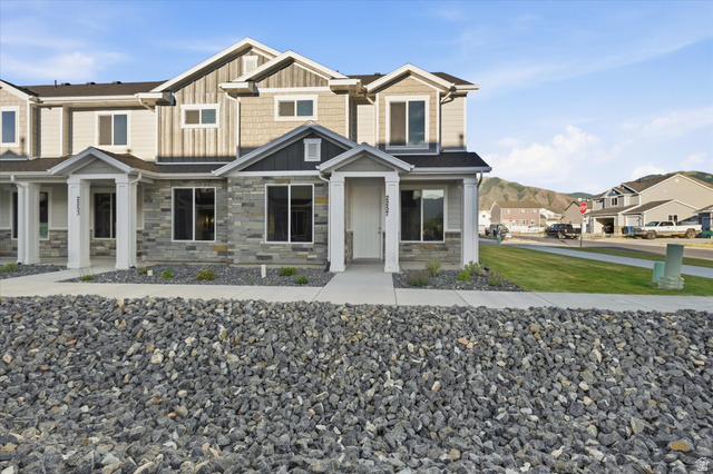 2257 South 1090 West, Unit 74 Nibley, UT 84321 - Photo 2 of 40 Contemporary multi-level townhome featuring a stone facade and vertical siding accents
