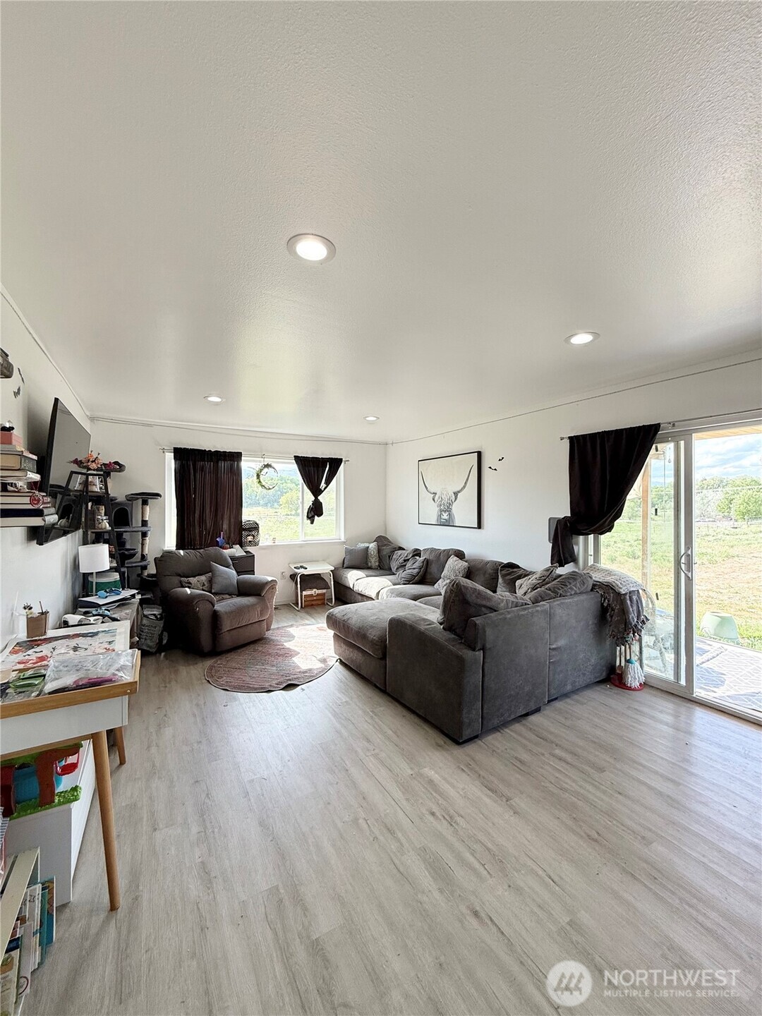 38 Miller Road Omak, WA 98841 - Photo 3 of 29 a living room with furniture a flat screen tv and a wooden floor