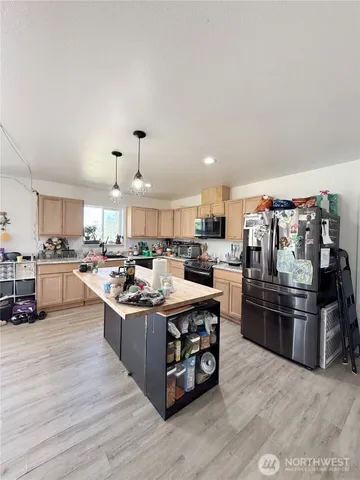 a kitchen with stainless steel appliances a stove a sink dishwasher and a refrigerator