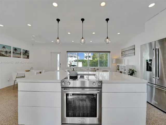 a kitchen with a stove a sink and a refrigerator