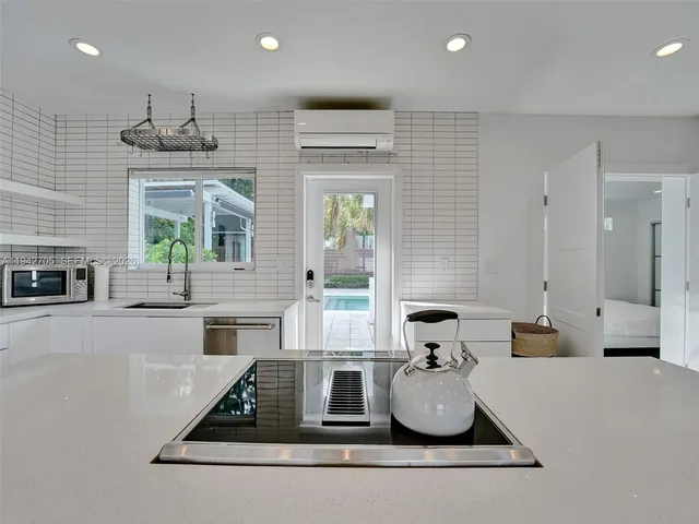 a room with kitchen island granite countertop furniture and a fireplace