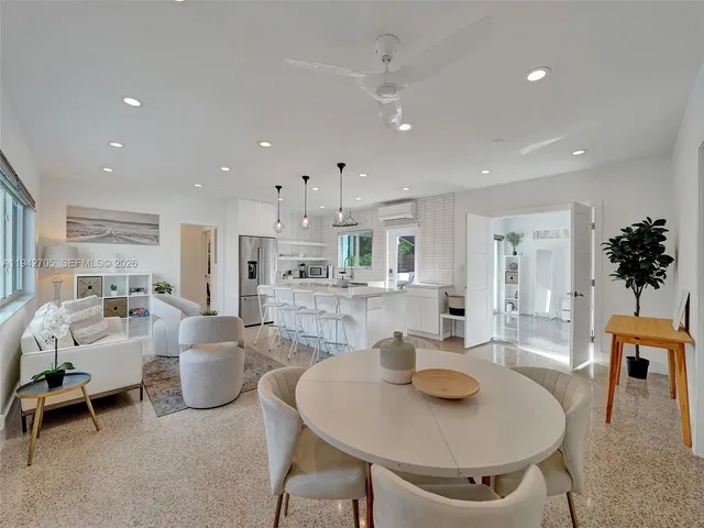 a view of a dining room with furniture and a kitchen