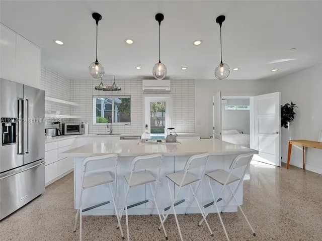 a large kitchen with a table and chairs