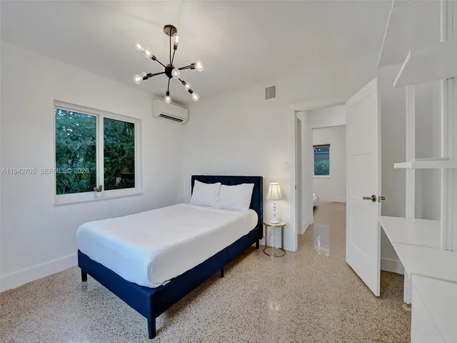 a bedroom with a bed and window