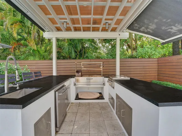 a kitchen with a sink and large windows