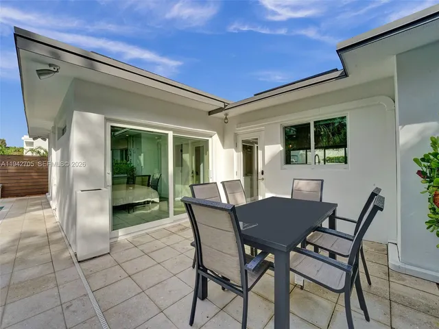 a view of a dining room with furniture and a potted plant