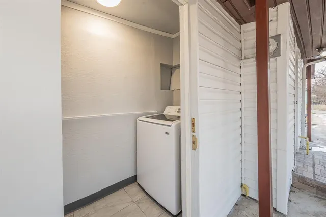 a view of a storage & utility room with a door