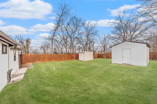 a view of a backyard with large trees