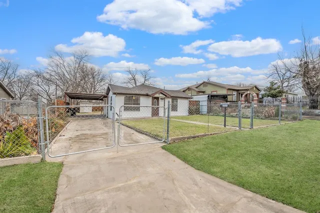 a view of a house with swimming pool and a yard
