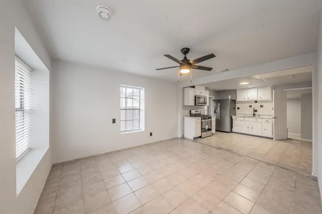 a view of a kitchen with a sink and a window